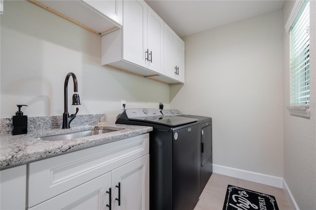 7257 Maguire Ln, Englewood, FL 34224 - laundry room with independent washer and dryer, cabinet space, and light tile patterned flooring
