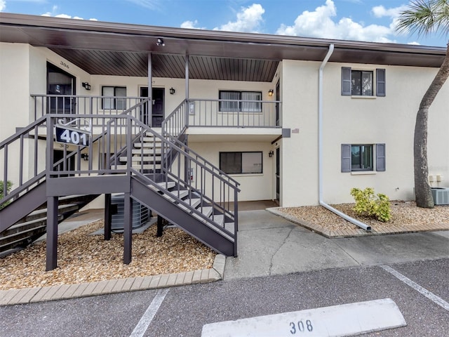 401 Airport Ave E Unit 304, Venice, FL 34285 - view of building exterior with uncovered parking and stairway