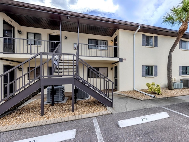 401 Airport Ave E Unit 304, Venice, FL 34285 - view of building exterior featuring stairs and uncovered parking