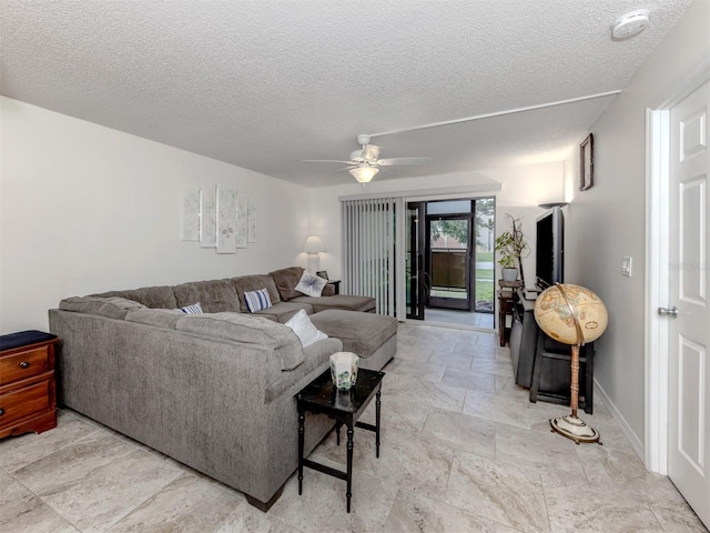 401 Airport Ave E Unit 304, Venice, FL 34285 - living area featuring stone tile floors, a textured ceiling, and a ceiling fan