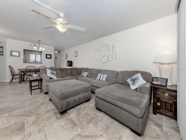 401 Airport Ave E Unit 304, Venice, FL 34285 - living area featuring a chandelier, ceiling fan, and a textured ceiling