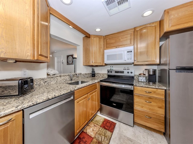 401 Airport Ave E Unit 304, Venice, FL 34285 - kitchen with stainless steel appliances, light stone counters, and recessed lighting