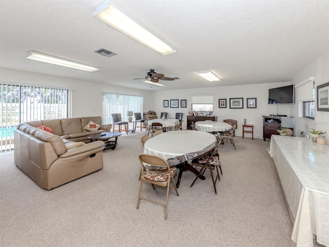 401 Airport Ave E Unit 304, Venice, FL 34285 - dining area featuring a textured ceiling, light carpet, and a ceiling fan
