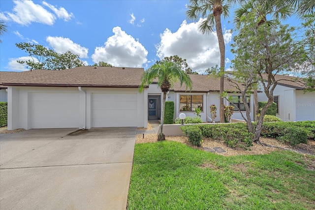 1211 Capri Isles Blvd Unit 6, Venice, FL 34292 - ranch-style home with an attached garage, concrete driveway, stucco siding, a front lawn, and a shingled roof