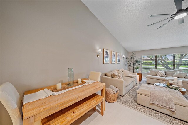 1211 Capri Isles Blvd Unit 6, Venice, FL 34292 - living room featuring ceiling fan, a textured ceiling, and high vaulted ceiling