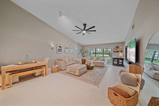 1211 Capri Isles Blvd Unit 6, Venice, FL 34292 - living room with healthy amount of natural light, ceiling fan, high vaulted ceiling, wood finished floors, and a textured ceiling