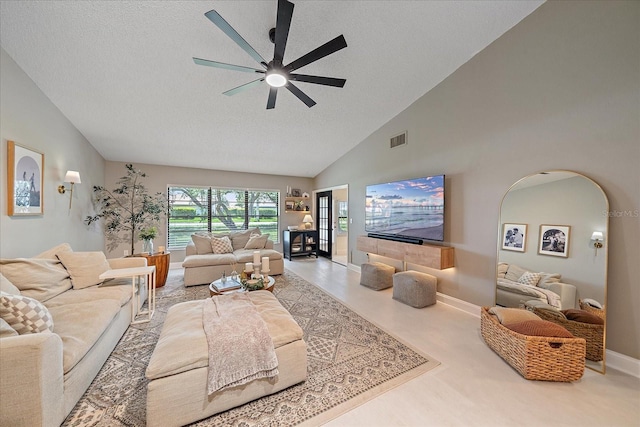 1211 Capri Isles Blvd Unit 6, Venice, FL 34292 - living room featuring a ceiling fan, high vaulted ceiling, a textured ceiling, and arched walkways