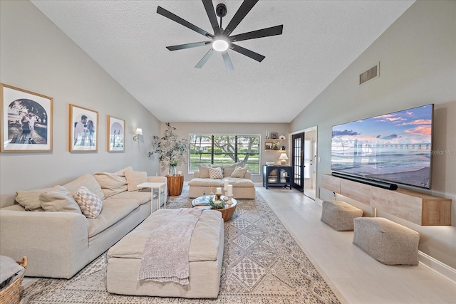 1211 Capri Isles Blvd Unit 6, Venice, FL 34292 - living area with a textured ceiling, ceiling fan, and high vaulted ceiling
