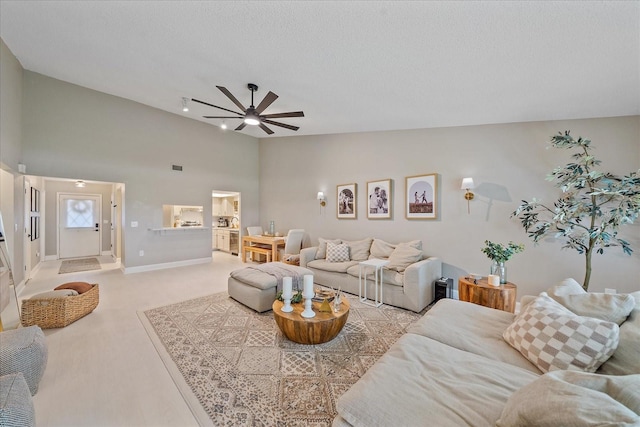 1211 Capri Isles Blvd Unit 6, Venice, FL 34292 - living room with a ceiling fan, light carpet, high vaulted ceiling, and a textured ceiling