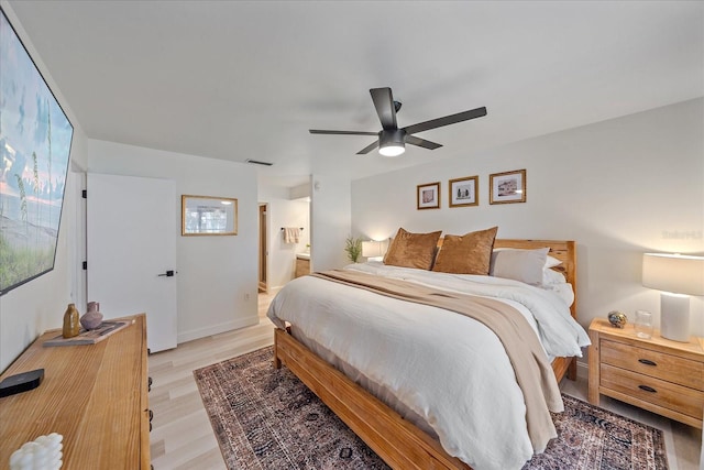 1211 Capri Isles Blvd Unit 6, Venice, FL 34292 - bedroom with light wood-style floors, multiple windows, ceiling fan, and connected bathroom