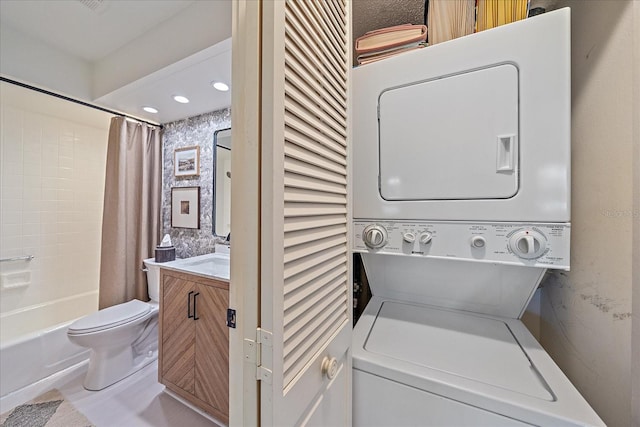 1211 Capri Isles Blvd Unit 6, Venice, FL 34292 - laundry area featuring stacked washer / drying machine, wallpapered walls, and recessed lighting