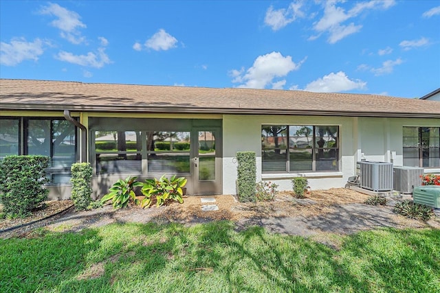 1211 Capri Isles Blvd Unit 6, Venice, FL 34292 - back of house featuring stucco siding and roof with shingles