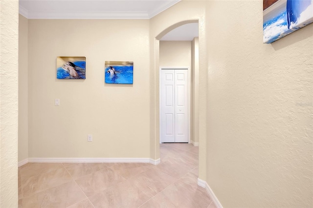 12187 Amica Loop, Venice, FL 34293 - hallway with arched walkways, crown molding, a textured wall, and light tile patterned flooring