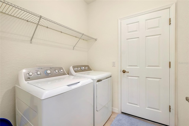 12187 Amica Loop, Venice, FL 34293 - laundry area with washing machine and clothes dryer and light tile patterned flooring