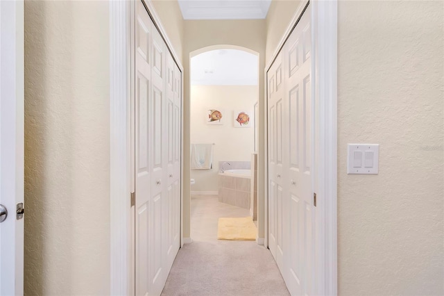 12187 Amica Loop, Venice, FL 34293 - hallway with arched walkways, a textured wall, and carpet flooring