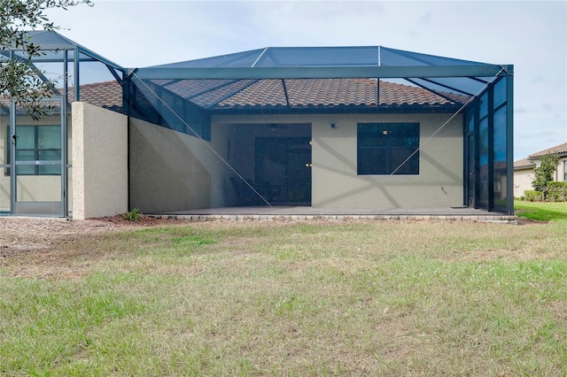 12187 Amica Loop, Venice, FL 34293 - back of property featuring a lanai, stucco siding, a lawn, and a tiled roof
