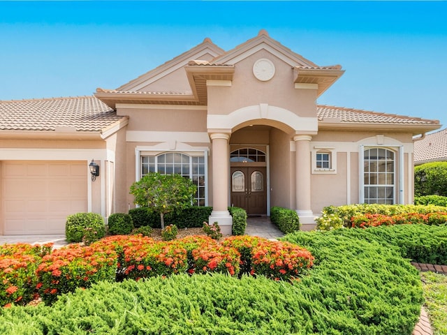 355 Swallow Cir, Venice, FL 34285 - view of front of house featuring an attached garage, stucco siding, and a tile roof