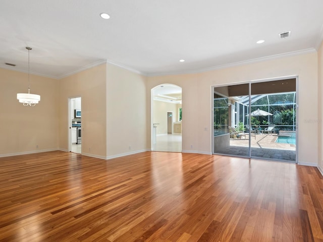 355 Swallow Cir, Venice, FL 34285 - unfurnished room featuring light wood-style floors, arched walkways, crown molding, and recessed lighting