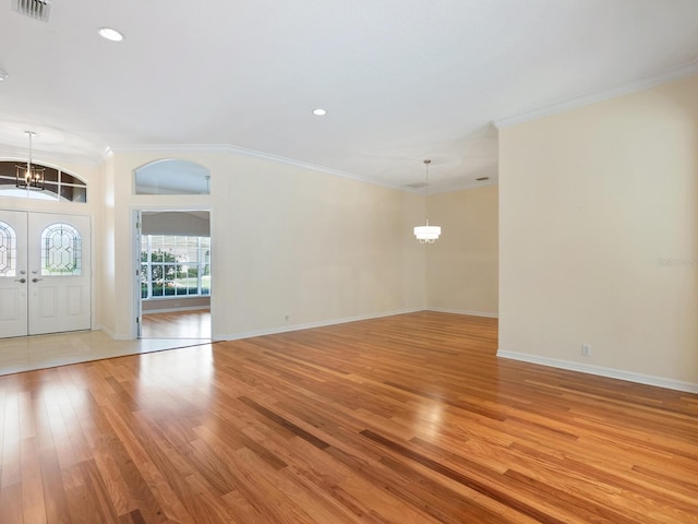 355 Swallow Cir, Venice, FL 34285 - entrance foyer with a chandelier, light wood-style floors, crown molding, and recessed lighting