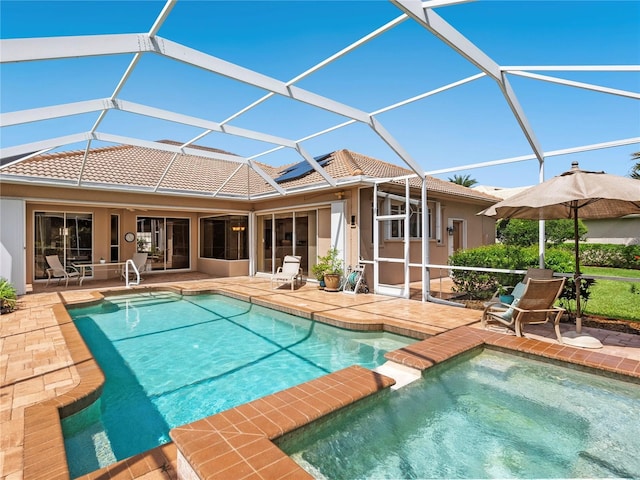 355 Swallow Cir, Venice, FL 34285 - back of property featuring a patio, a tiled roof, stucco siding, and a lanai