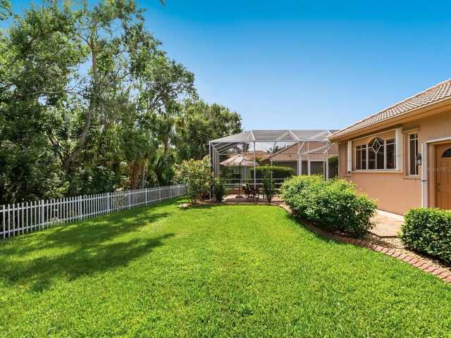 355 Swallow Cir, Venice, FL 34285 - fenced backyard with a lanai