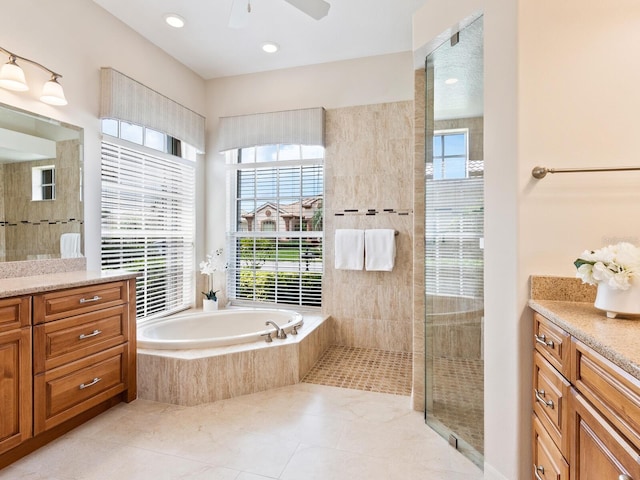 355 Swallow Cir, Venice, FL 34285 - full bath featuring vanity, a garden tub, tile patterned floors, a ceiling fan, and tiled shower