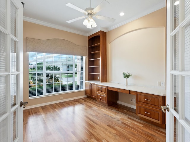 355 Swallow Cir, Venice, FL 34285 - unfurnished office with built in desk, crown molding, light wood-style floors, and ceiling fan