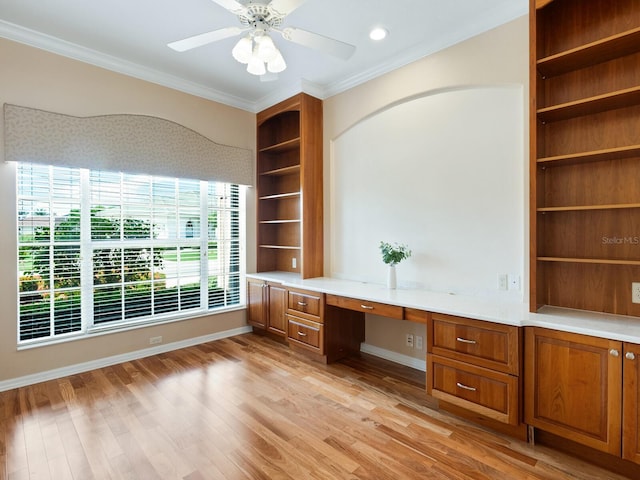 355 Swallow Cir, Venice, FL 34285 - unfurnished office featuring built in desk, crown molding, light wood-style floors, and a ceiling fan