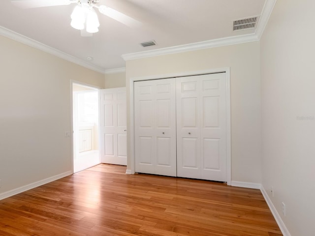 355 Swallow Cir, Venice, FL 34285 - unfurnished bedroom with crown molding, light wood-style floors, a closet, and ceiling fan