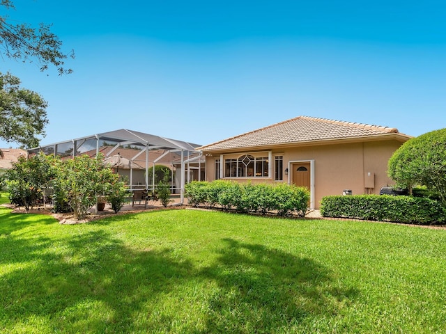 355 Swallow Cir, Venice, FL 34285 - rear view of property featuring stucco siding, a tile roof, a yard, and glass enclosure