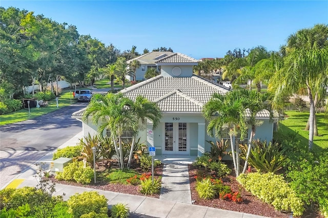 700 Gardens Edge Dr Unit 722, Venice, FL 34285 - mediterranean / spanish house with french doors, a tile roof, and stucco siding