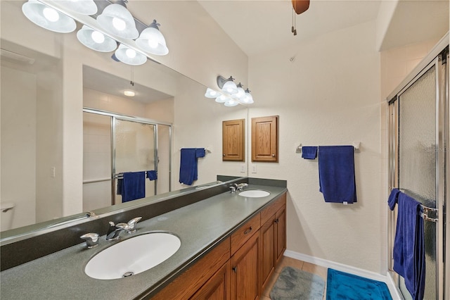 700 Gardens Edge Dr Unit 722, Venice, FL 34285 - full bathroom with double vanity, a shower stall, tile patterned floors, and a ceiling fan