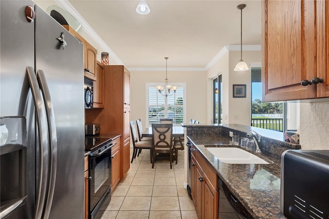 700 Gardens Edge Dr Unit 722, Venice, FL 34285 - kitchen with black appliances, light tile patterned floors, a chandelier, crown molding, and brown cabinets