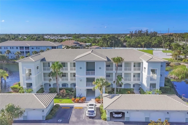 700 Gardens Edge Dr Unit 722, Venice, FL 34285 - view of building exterior with uncovered parking, a water view, and a residential view