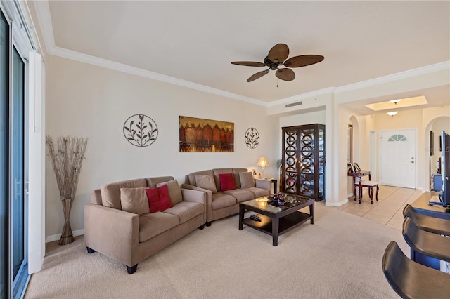 700 Gardens Edge Dr Unit 722, Venice, FL 34285 - living area with arched walkways, crown molding, ceiling fan, light carpet, and light tile patterned flooring