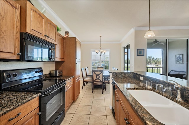 700 Gardens Edge Dr Unit 722, Venice, FL 34285 - kitchen featuring black appliances, brown cabinetry, crown molding, decorative light fixtures, and a chandelier