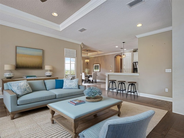 5832 Semolino St, Nokomis, FL 34275 - living area featuring wood finished floors, a textured ceiling, recessed lighting, and ornamental molding