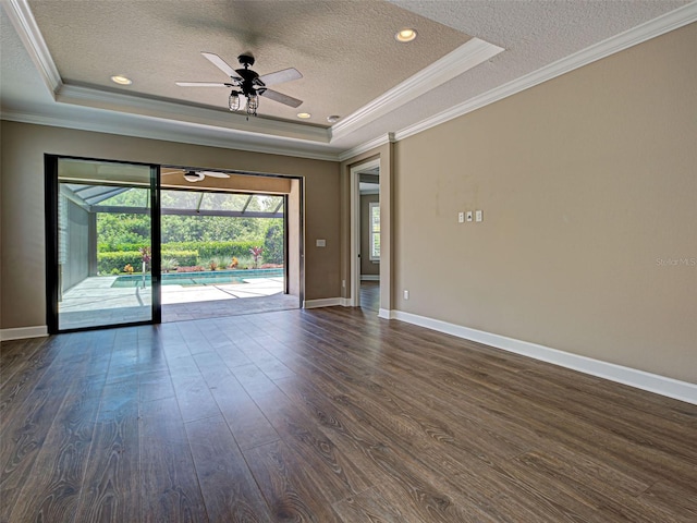 5832 Semolino St, Nokomis, FL 34275 - spare room with a tray ceiling, a textured ceiling, ornamental molding, dark wood-style floors, and ceiling fan