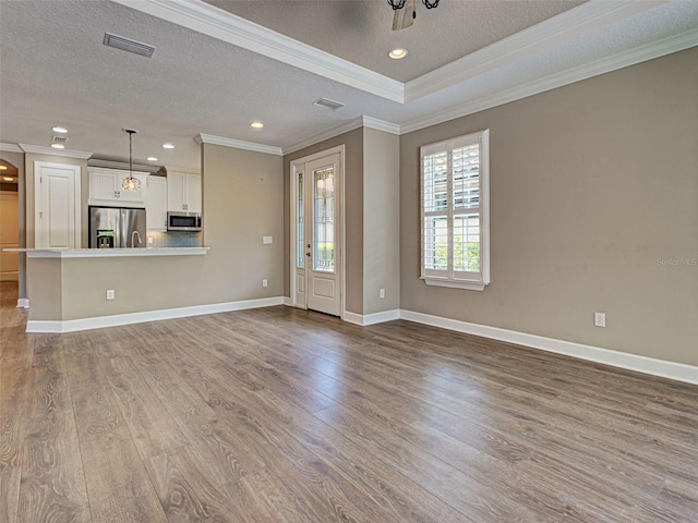 5832 Semolino St, Nokomis, FL 34275 - unfurnished living room featuring a textured ceiling, ornamental molding, wood finished floors, and recessed lighting