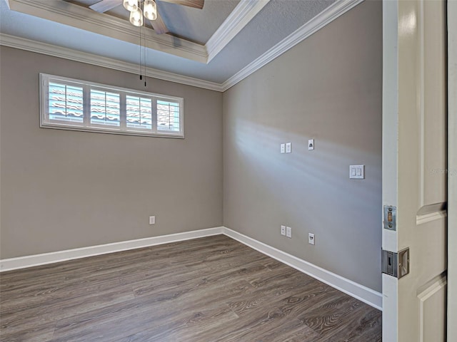 5832 Semolino St, Nokomis, FL 34275 - empty room with a tray ceiling, dark wood-style flooring, ceiling fan, and ornamental molding