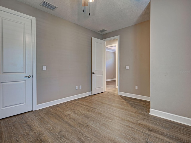 5832 Semolino St, Nokomis, FL 34275 - unfurnished room featuring wood finished floors, a textured ceiling, and a ceiling fan