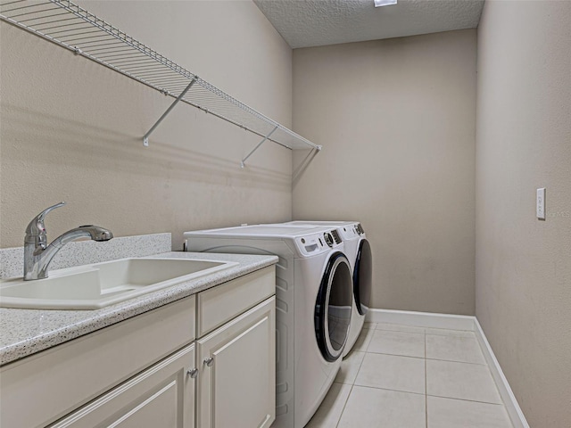 5832 Semolino St, Nokomis, FL 34275 - laundry area with washing machine and dryer, light tile patterned floors, cabinet space, and a textured ceiling