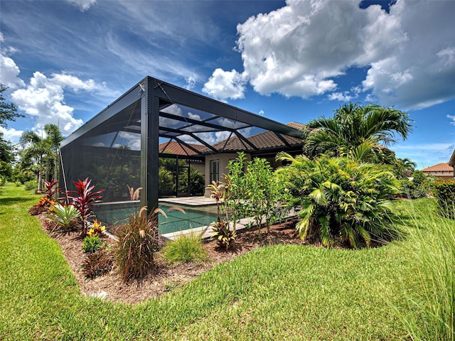 5832 Semolino St, Nokomis, FL 34275 - rear view of house with a yard, an outdoor pool, and glass enclosure