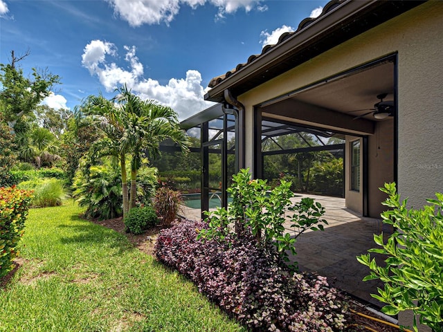 5832 Semolino St, Nokomis, FL 34275 - view of green lawn featuring a patio, an outdoor pool, glass enclosure, and a ceiling fan