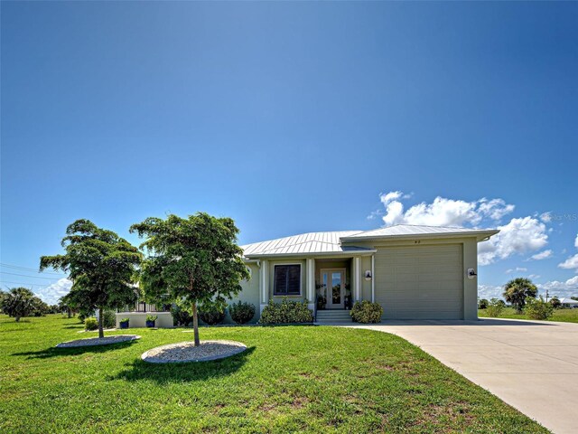 48 Lark Dr, Placida, FL 33946 - ranch-style home with french doors, concrete driveway, a garage, and a front yard