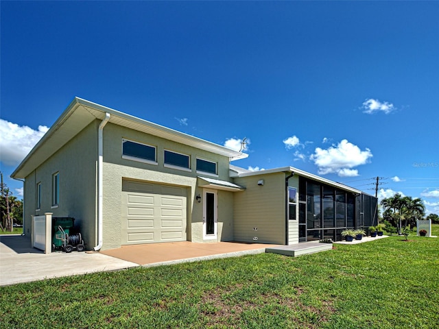 48 Lark Dr, Placida, FL 33946 - back of property featuring a yard, a garage, a sunroom, and stucco siding