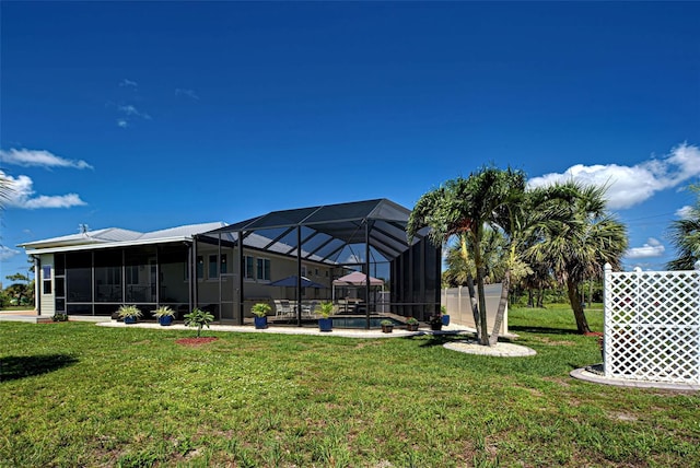48 Lark Dr, Placida, FL 33946 - view of green lawn with a patio area, an outdoor pool, and a lanai