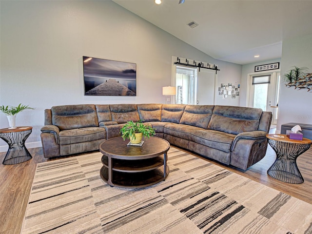 48 Lark Dr, Placida, FL 33946 - living room with lofted ceiling, wood finished floors, and recessed lighting