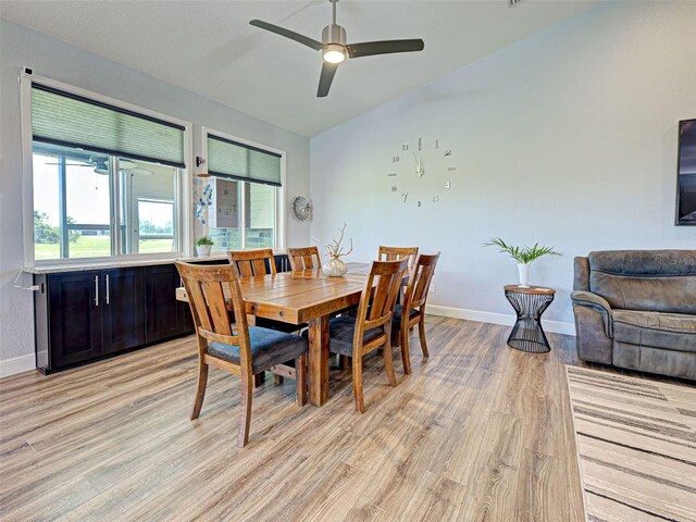 48 Lark Dr, Placida, FL 33946 - dining area featuring light wood-style floors, a ceiling fan, and vaulted ceiling