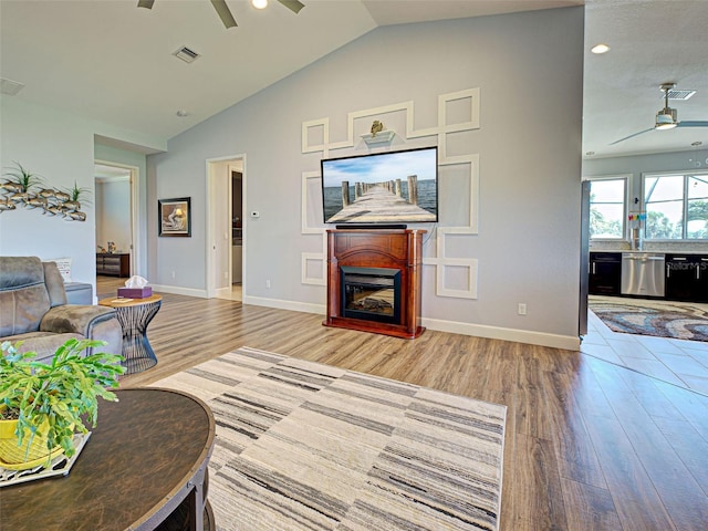 48 Lark Dr, Placida, FL 33946 - living room with a ceiling fan, wood finished floors, lofted ceiling, a fireplace, and recessed lighting
